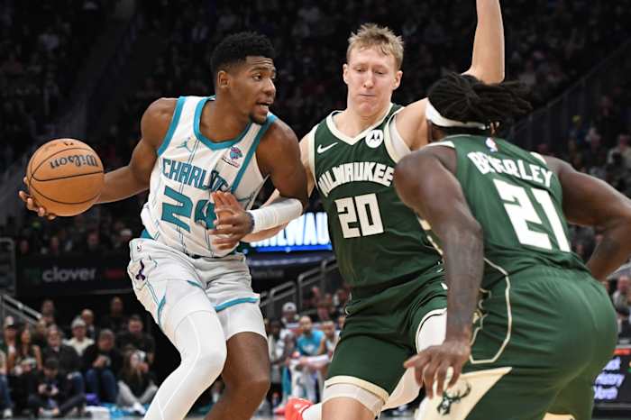 Charlotte Hornets forward Brandon Miller (24) drives against Milwaukee Bucks guard AJ Green (20) and guard Patrick Beverley (21)
